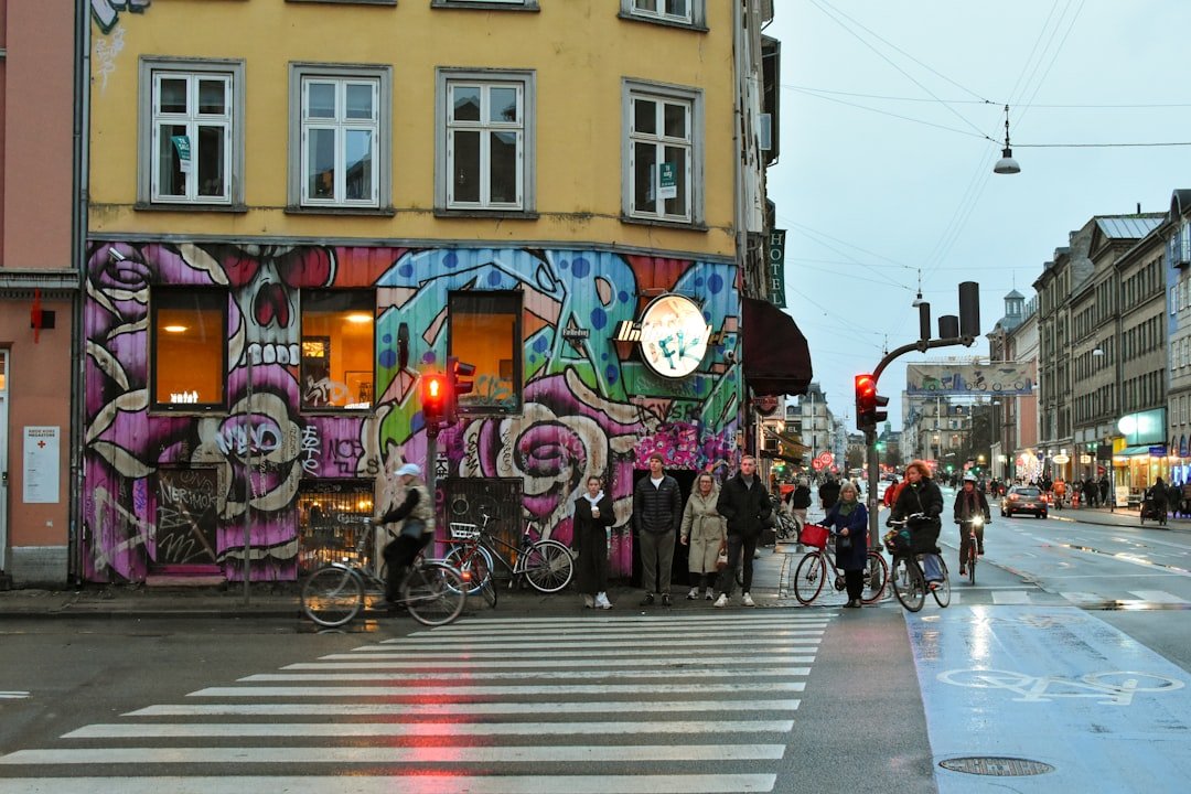 Street style photographers capturing fashionable attendees outside Copenhagen Fashion Week venue in winter 2026