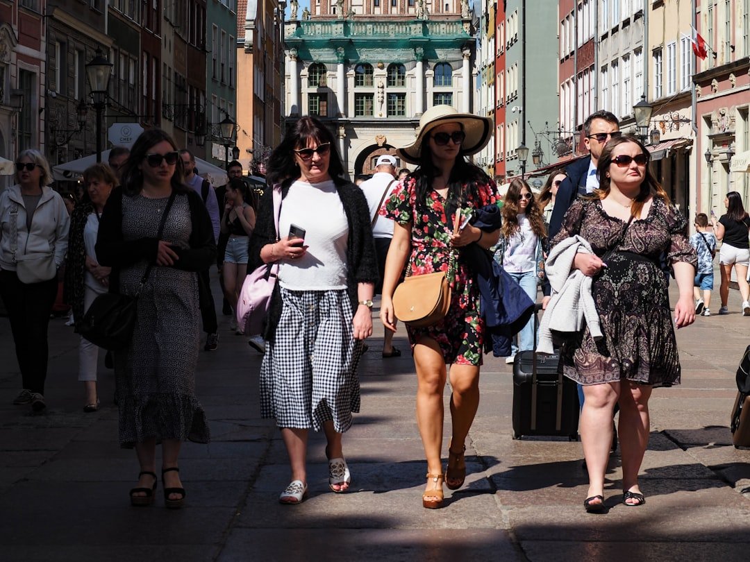 Diverse group of stylish people on city street wearing mixed international fashion influences