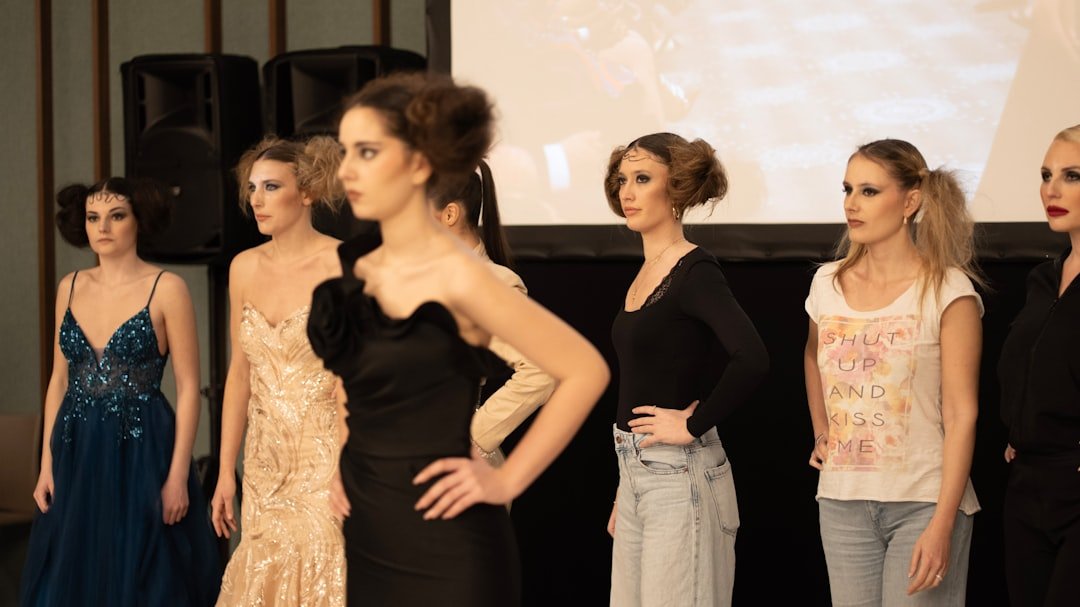 Models walking spring 2026 runway in Milan wearing flowing sheer fabrics and structured shoulders