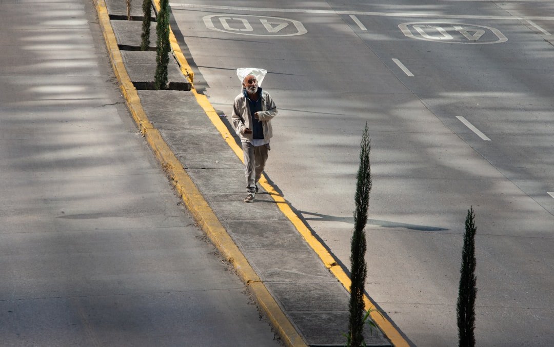 Street style photo of woman wearing silver metallic midi skirt with casual white t-shirt
